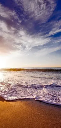 Enjoy the tranquil beauty of a beach with waves crashing in this stunning live wallpaper for your phone