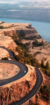 Looking for a stunning live wallpaper for your phone? Look no further than our Portland, Oregon panorama wallpaper! This mesmerizing video captures the beauty of the Pacific Northwest with a winding road, tranquil body of water and impressive cliffside all in one shot