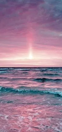 This live wallpaper features a stunning scene of a pink sky above the ocean, with waves gently crashing onto the shore