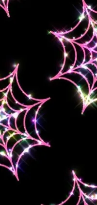 This phone live wallpaper features a digital rendering of a spider web on a black background, with intricate details and geometric patterns visible in bright colors, including pink diamonds