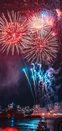 This phone live wallpaper is a stunning display of colorful fireworks lighting up the night sky