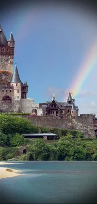 This phone live wallpaper depicts a castle atop a green hillside with rainbow reflections