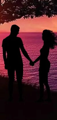This gorgeous live wallpaper features a romantic scene of a couple holding hands near a tree at sunset while gazing at the golden sun slowly setting behind them