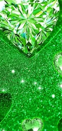 This phone live wallpaper features a heart-shaped diamond in stunning close-up detail against a vibrant green backdrop filled with lucky clovers