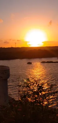 This stunning live wallpaper features a beautiful sunset over a body of water in Cuba