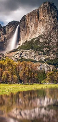 This phone live wallpaper depicts a serene body of water and waterfall, surrounded by a mountain and meadow in California