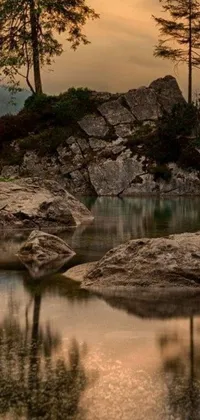 This phone live wallpaper showcases a tranquil body of water, surrounded by rocky terrain and lush foliage