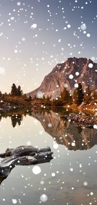 This phone live wallpaper showcases a soothing mountain-lake landscape with a snow-clad peak beside it