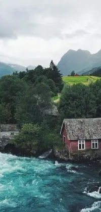 This gorgeous phone live wallpaper showcases a red house on a lush green hillside amidst river rapids
