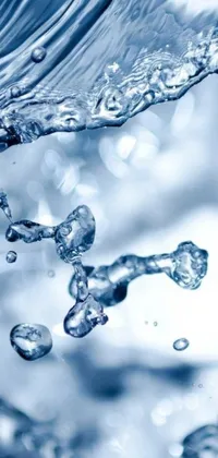 This phone live wallpaper features a captivating close-up of blue water with bubbles floating to the surface