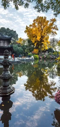 This stunning live wallpaper for phones features a serene pond surrounded by trees, an Autumn garden, and a Chinese building