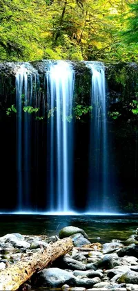 This live wallpaper depicts a mesmerizing waterfall at the heart of a green forest