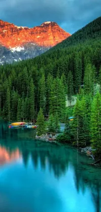 Adorn your phone with a breathtaking live wallpaper featuring a serene lake and towering mountain landscape in the vibrant red and green hues