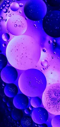 Experience the mesmerizing beauty of vibrant purple and blue bubbles through this dazzling live wallpaper! Inspired by microscopic photography, this wallpaper features intricately patterned bubbles in various shades, pulsating with life-like movement