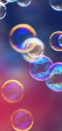 This phone live wallpaper features a mesmerizing display of soap bubbles, gently floating amidst a backdrop of bokeh lights