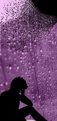 This phone live wallpaper is a stunning digital art piece featuring a silhouette of a person sitting on a window sill in the rain