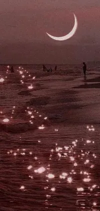 Looking for a stunning live wallpaper for your phone? Check out this photo of a group of people viewing a crimson moon on a beach by the ocean! Colorized for a dreamy vibe, the image features glowing pink fireflies and ethereal bubbles, alongside red reflective lens flares for added drama