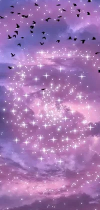 This phone live wallpaper depicts a mesmerizing scene of birds flying through a cloudy sky, set against a starry purple and blue galaxy