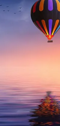 This phone live wallpaper features a hot air balloon gracefully gliding above a serene body of water