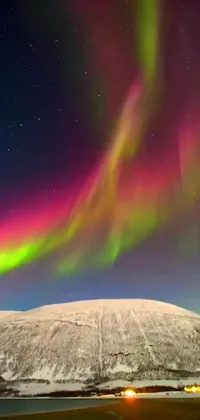 Transform your phone screen into a winter wonderland with this live wallpaper featuring a stunning display of aurora lights above a snow-covered mountain