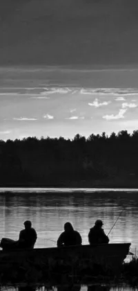 This live wallpaper for your phone features a black and white photo of a group of people fishing in a boat on a tranquil lake at dusk