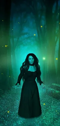 This forest live wallpaper for phones presents a stunning digital art of a gothic girl casting spells in the dark of the night