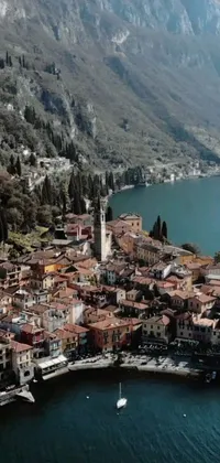 This phone live wallpaper depicts an aerial view of a picturesque town beside a serene body of water