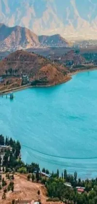 This phone live wallpaper showcases a stunning body of water surrounded by mountains that would be a nature lover's paradise