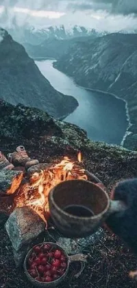 This phone live wallpaper is a beautiful depiction of a group of people gathered around a campfire