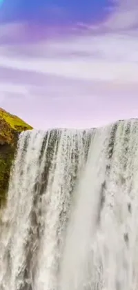 This interactive phone live wallpaper features a magnificent waterfall with a rainbow backdrop, capture with a tilt shift technique, evoking a dreamy aesthetic