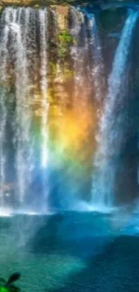 This captivating live phone wallpaper features a digital rendering of a mesmerizing waterfall with a rainbow situated in the center