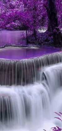 This stunning live phone wallpaper depicts a serene purple waterfall amidst a lush forest setting
