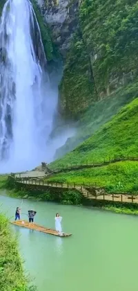 This phone live wallpaper showcases a stunning image of people standing on a wooden raft in front of a mesmerizing waterfall
