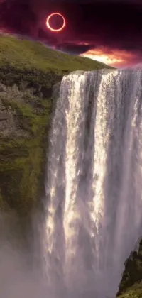 This phone live wallpaper features a digital rendering of a large waterfall set amidst a lush green field in Reykjavik