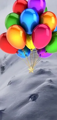 This live mobile wallpaper features a vibrant display of colorful balloons drifting through a beautiful, colorized image of snow-capped mountain ranges