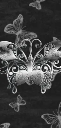 Looking for a stunning phone live wallpaper? Look no further than this black and white photo of a butterfly! This stipple design is inspired by the art nouveau movement with its detailed silver metal ornaments and delicate silver jewelry