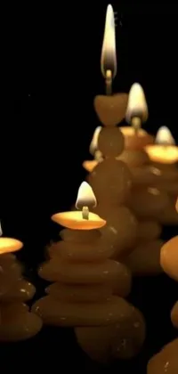 This phone live wallpaper depicts a digital rendering of a group of candles, made of glowing wax and ceramic