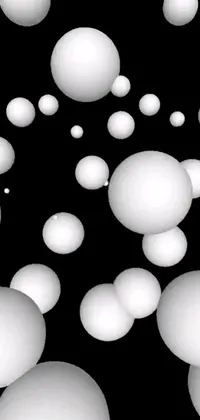 This phone live wallpaper boasts a stunning black and white photo of various balls