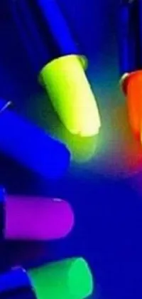This live wallpaper for phones boasts a stunning display of neon pens arranged on a sleek table