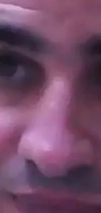 Get this unique live wallpaper for your phone today! It features an extreme close-up of a man's face as he chats on his mobile