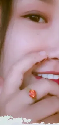 This live wallpaper for your phone features a mesmerizing close-up portrait of a person wearing a ring