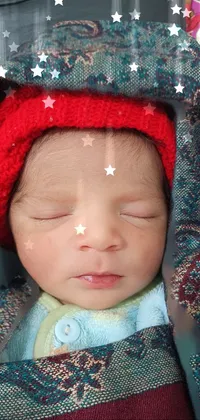 This phone live wallpaper features a captivating close-up photograph of a baby with a red hat