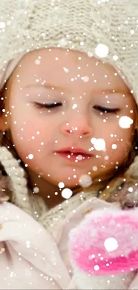 This phone live wallpaper features a delightful winter scene of a young girl standing in the snow, symbolizing innocence and purity