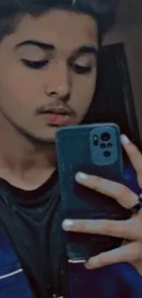 Download this live wallpaper for your phone featuring a young man taking a mirror selfie