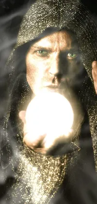This is a live wallpaper featuring an image of a man holding a glowing ball in his hand with a magical realism quality