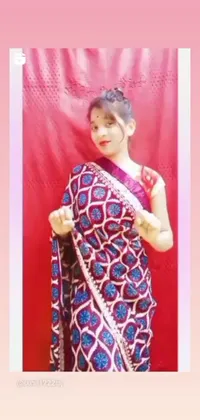 This vibrant phone live wallpaper features a woman adorned in a colorful sari, striking a pose for a picture in front of a red and blue tachisme-inspired background