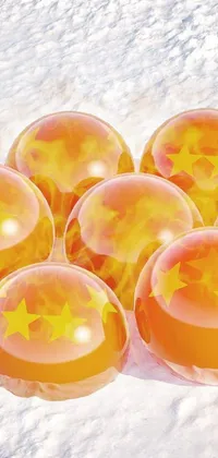 This live phone wallpaper features a snowy landscape adorned with bright orange balls