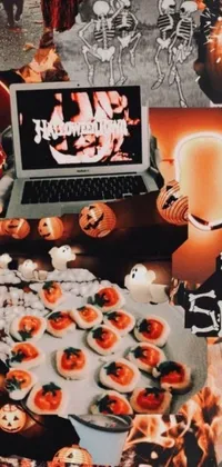 This Halloween-themed phone live wallpaper displays a laptop on a table adorned with spooky decorations