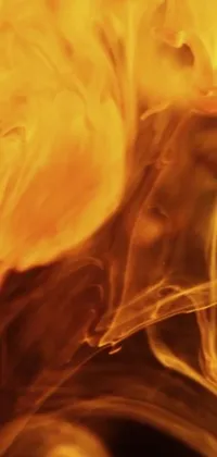 This stunning live wallpaper features a close-up view of a person holding a cell phone, with a gorgeous fire texture and liquid translucent amber effect