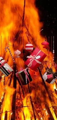 This lively live wallpaper features a festive fire with lots of colorful presents and candy decorations hung from it